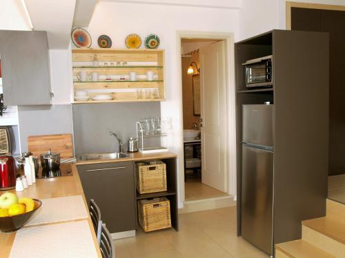 a kitchen with a stainless steel refrigerator at The Garden of Zephyrus - East in Pithárion