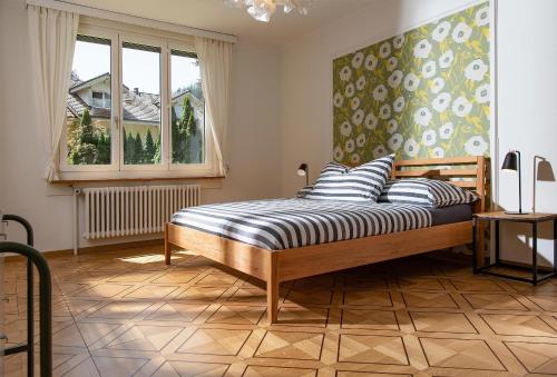 a bedroom with a bed and a window at Boutique Villa J87 in Interlaken