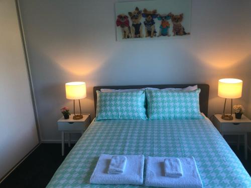 a bedroom with a bed with two towels on it at CandE on Samphire in Kingscote