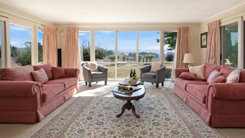 a living room with two couches and a table at Warrington Park in Berrima