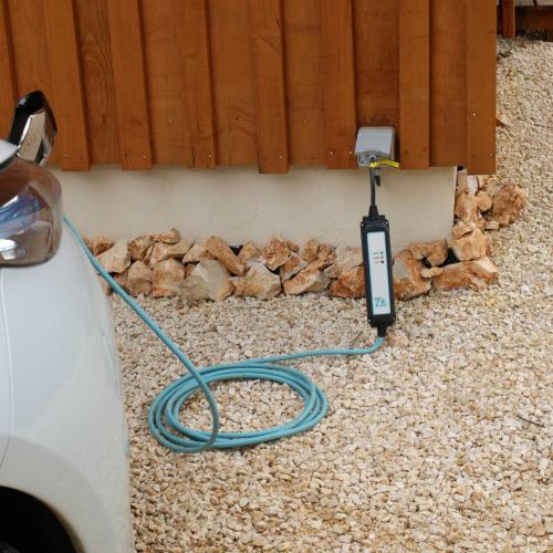 a electric car charger hooked up to a wall at Gite et cabane écologiques 1000 Pailles in Labastide-de-Virac