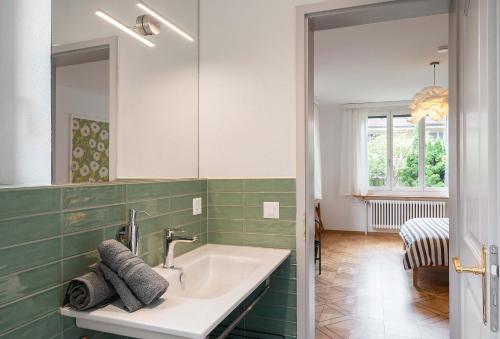 La salle de bains est pourvue d'un lavabo et d'un miroir. dans l'établissement Boutique Villa J87, à Interlaken