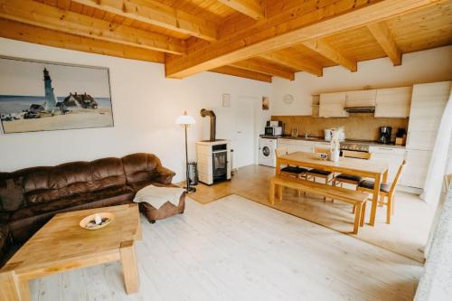 a living room with a couch and a table at Haus Mimi Zarrentin am Schaalsee in Zarrentin