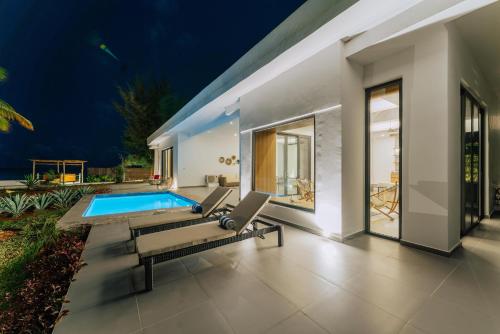 a villa with a swimming pool at night at Safira Blu Luxury Resort & Villas in Nungwi