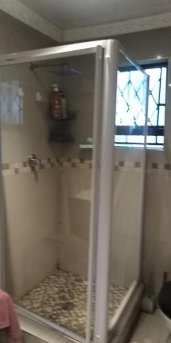 a shower with a glass door in a bathroom at VIP Deluxe Restroom Zone in Durban