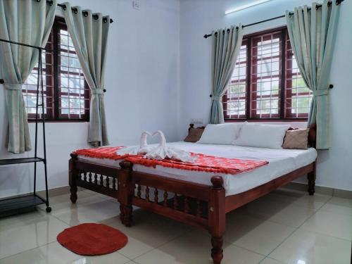 a bedroom with a bed in a room with windows at joseys homestay in Cochin