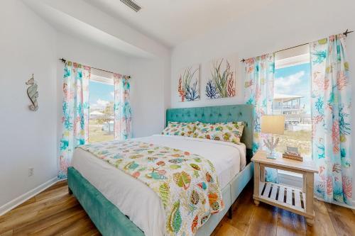 a bedroom with a bed and two windows at Memory Maker in St. George Island