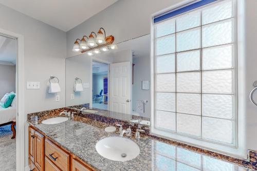 a bathroom with a sink and a large window at Canal Rancho in Padre Island