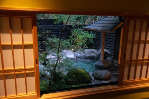 a view of a garden through a window at Baien in Yufuin