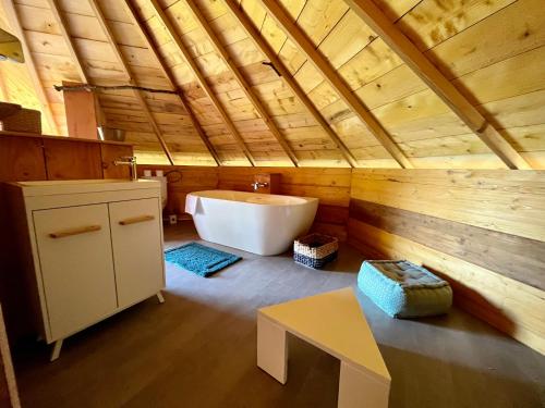 a bathroom with a tub and a sink at Domaine d'Escapa in Estipouy