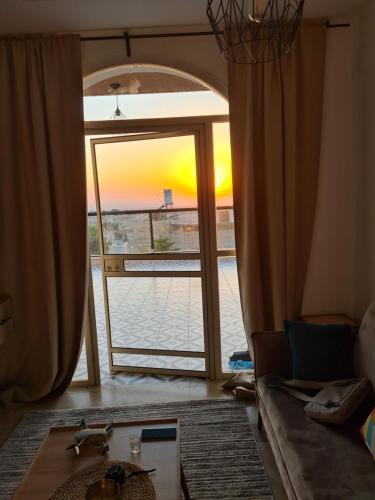 a living room with a view of a sunset through a door at סוויטה בכפר ירכא in Yarka