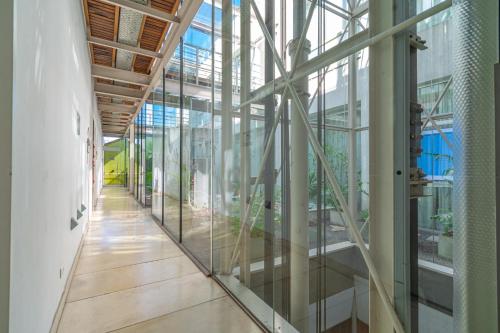 a hallway with glass walls in a building at Hotel BA Jardines Palermo in Buenos Aires