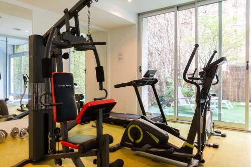 a gym with treadmills and elliptical machines at Hotel BA Jardines Palermo in Buenos Aires