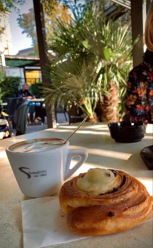 a cup of coffee and a pastry on a table at Una Chicca a Roma in Rome