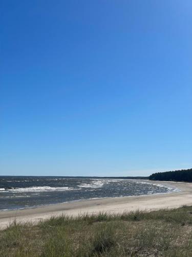 a beach with the ocean in the background at Divas Laivas apartments with a terrace in Ķesterciems