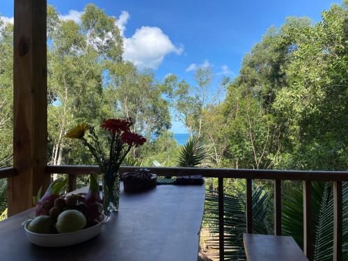 a bowl of fruit on a table on a balcony at COZY HOME PHU QUOC in Phu Quoc