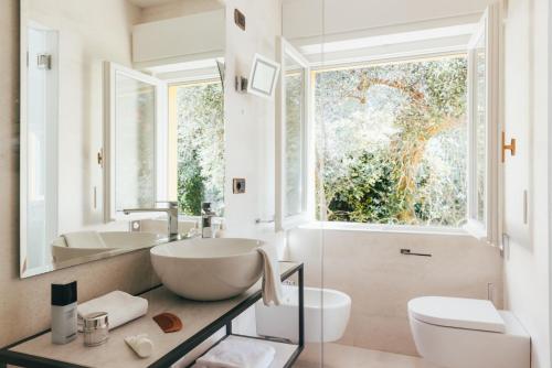 a bathroom with a large bowl sink and a window at Hotel Orione - Lake Front Hotel in Brenzone sul Garda