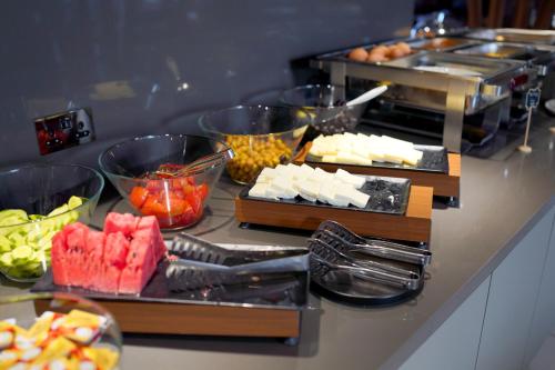 a buffet with different types of food on a counter at Sky Roof Hotel in North Nicosia