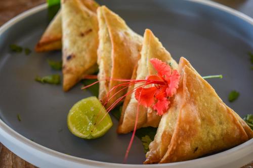 a plate of food with a group of sandwiches at Safira Blu Luxury Resort & Villas in Nungwi