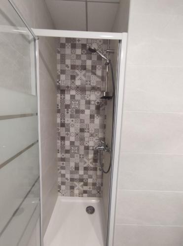 a shower with a glass door in a bathroom at Albir cosy apartment in Albir