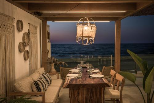 a dining table with a view of the ocean at Enorme Maya Beach Hotel-Adults Only in Gouves