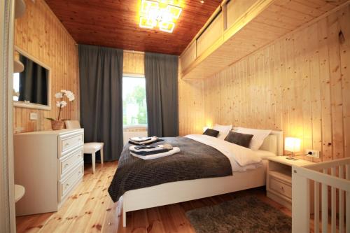 a bedroom with a bed and a desk and a window at East side in Tervola with sauna and free parking in Tervola