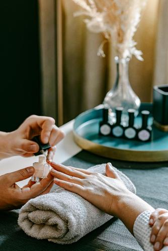 a woman getting her nails done at a table at Experimental Chalet in Verbier