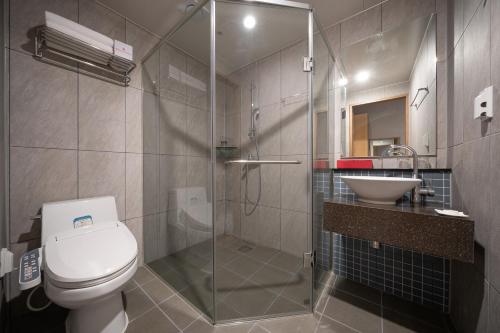 a bathroom with a shower and a toilet and a sink at Ramada by Wyndham Seoul Dongdaemun in Seoul