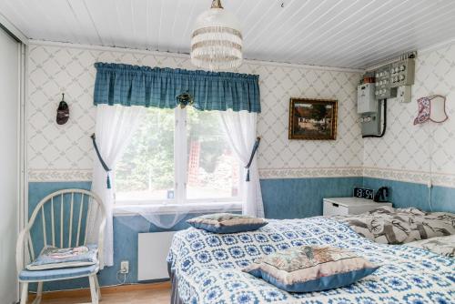 a bedroom with a bed and a window at Cottage with own jetty in Ljungbyhed in Ljungbyhed