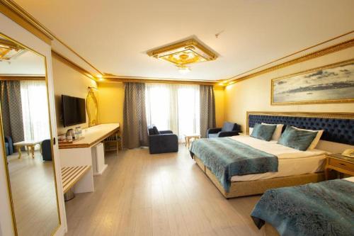 a hotel room with two beds and two lamps at Phosphorion in Istanbul