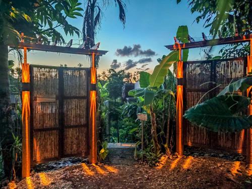 an entrance gate to a garden at dusk at The River Hideaway in General Luna