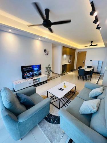 a living room with two couches and a flat screen tv at R&F PRINCESS COVE at ANJU in Johor Bahru