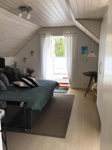 a bedroom with a bed and a large window at Vejlen Bed & Kitchen in Vadum