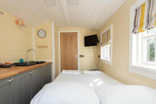 uma pequena cozinha com duas camas num quarto em Elsie's Retreat em Durham