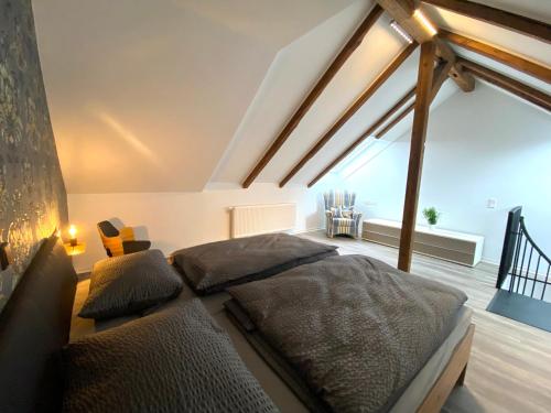 a bedroom with a large bed in a attic at Ferienwohnungen zur alten PuppenFabrik in Sonneberg