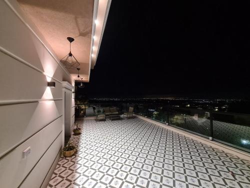 a balcony with a view of a city at night at סוויטה בכפר ירכא in Yarka