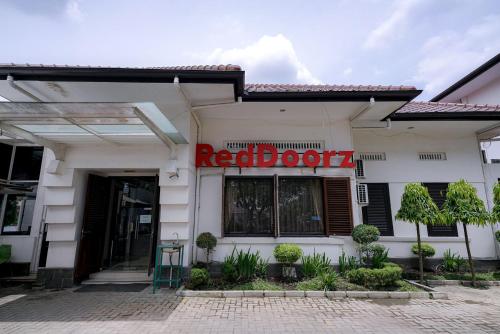 a red sign on the front of a restaurant at RedDoorz @ Avros Guest House Medan in Medan