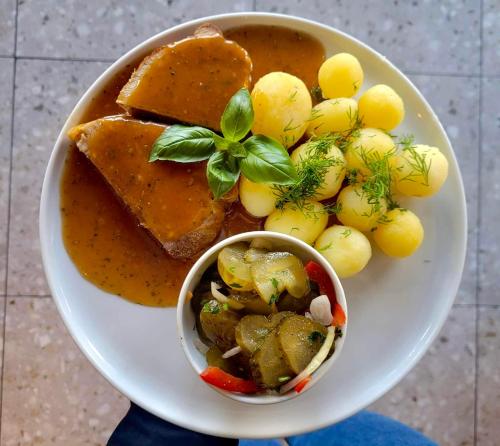 a plate of food with a bowl of soup and grapes at SIECHNICE Noclegi in Siechnice