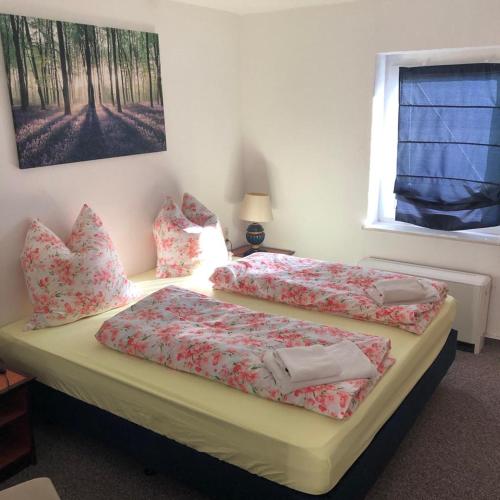 a bedroom with two beds and a window at Pension Rudolph Riesa in Riesa