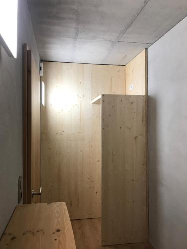 a room with a wooden door and a wall at Kieferhof in Iselsberg