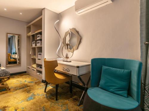 a room with a desk and two chairs at Madamz Bed & Breakfast in Gaborone