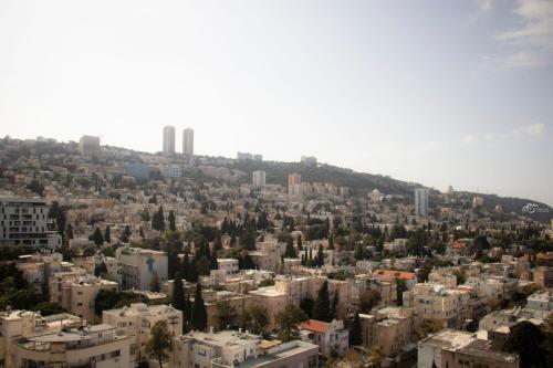 an aerial view of a city with buildings at Haifa Peak in Haifa