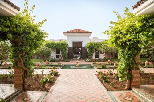 a courtyard of a house with a fountain at ROBINSON AGADIR - All Inclusive in Agadir