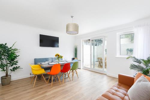 een eetkamer en een woonkamer met een tafel en stoelen bij Beachside Retreat 2-Bedroom Gem with FREE Private Parking & Outdoor Space in Brighton & Hove