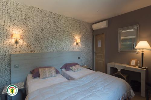 a bedroom with two beds in a room at Le Val des Sens in Chatte