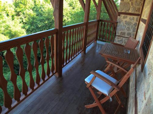 a wooden balcony with a table and a chair at Boutique Hotel Kokkino Spiti in Veria
