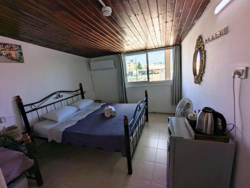 a bedroom with a bed with a blue comforter at New Citadel Hostel in Jerusalem