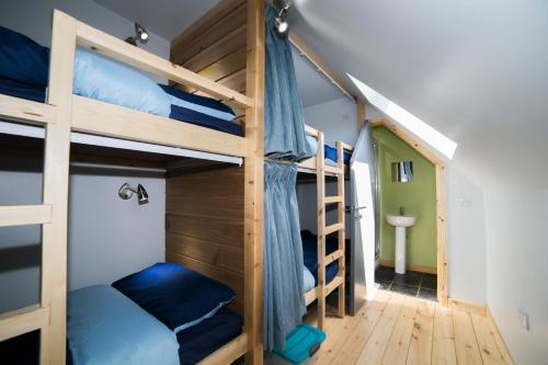 a room with bunk beds and a hallway at Tarset Tor - Bothy 1 in Greenhaugh