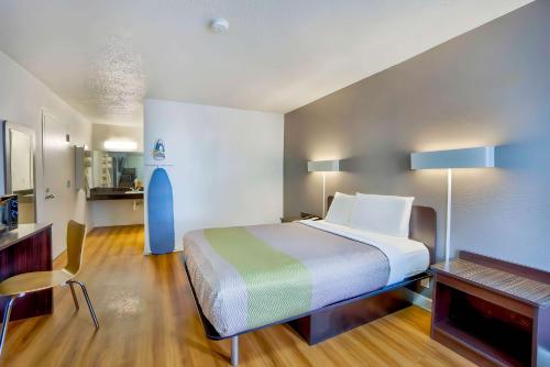 a hotel room with a bed and a kitchen at Studio 6 Gainesville, Fl in Gainesville