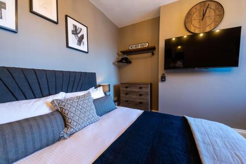 a bedroom with a bed and a flat screen tv at Veyron Apartments - part of the V Group in Blackpool